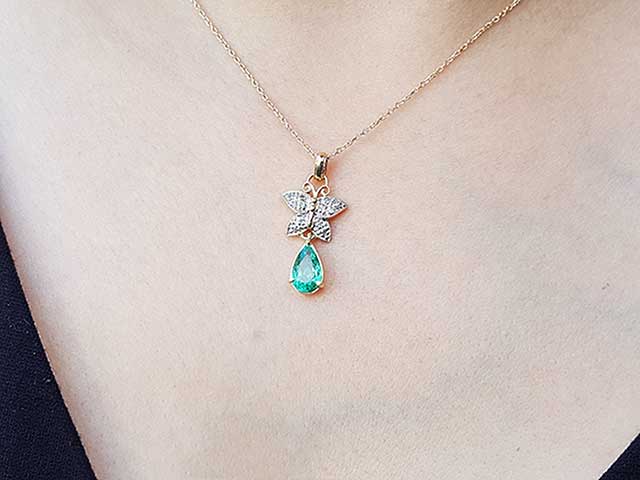 Emerald and diamond butterfly pendant necklce
