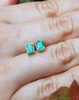 Solid gold stud earrings with emeralds