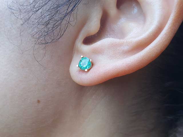 Round cut emerald stud earrings