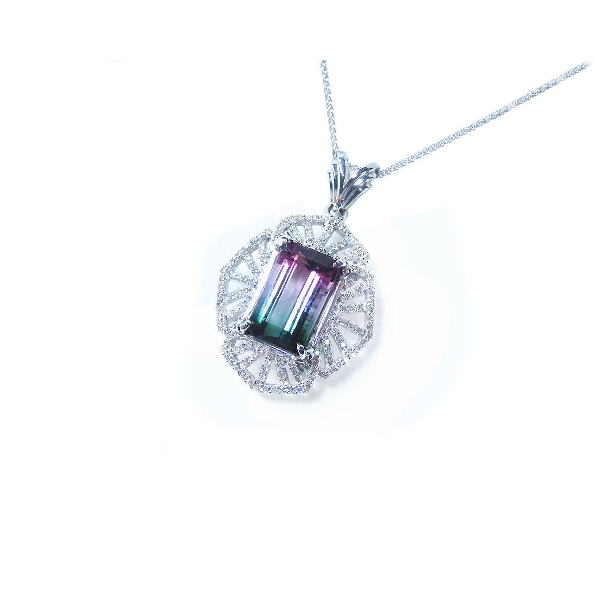 A tourmaline and diamond necklace in white gold with on a white background.