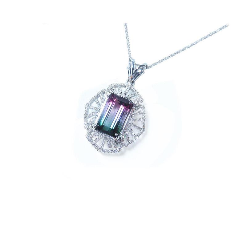 A tourmaline and diamond necklace in white gold with on a white background.
