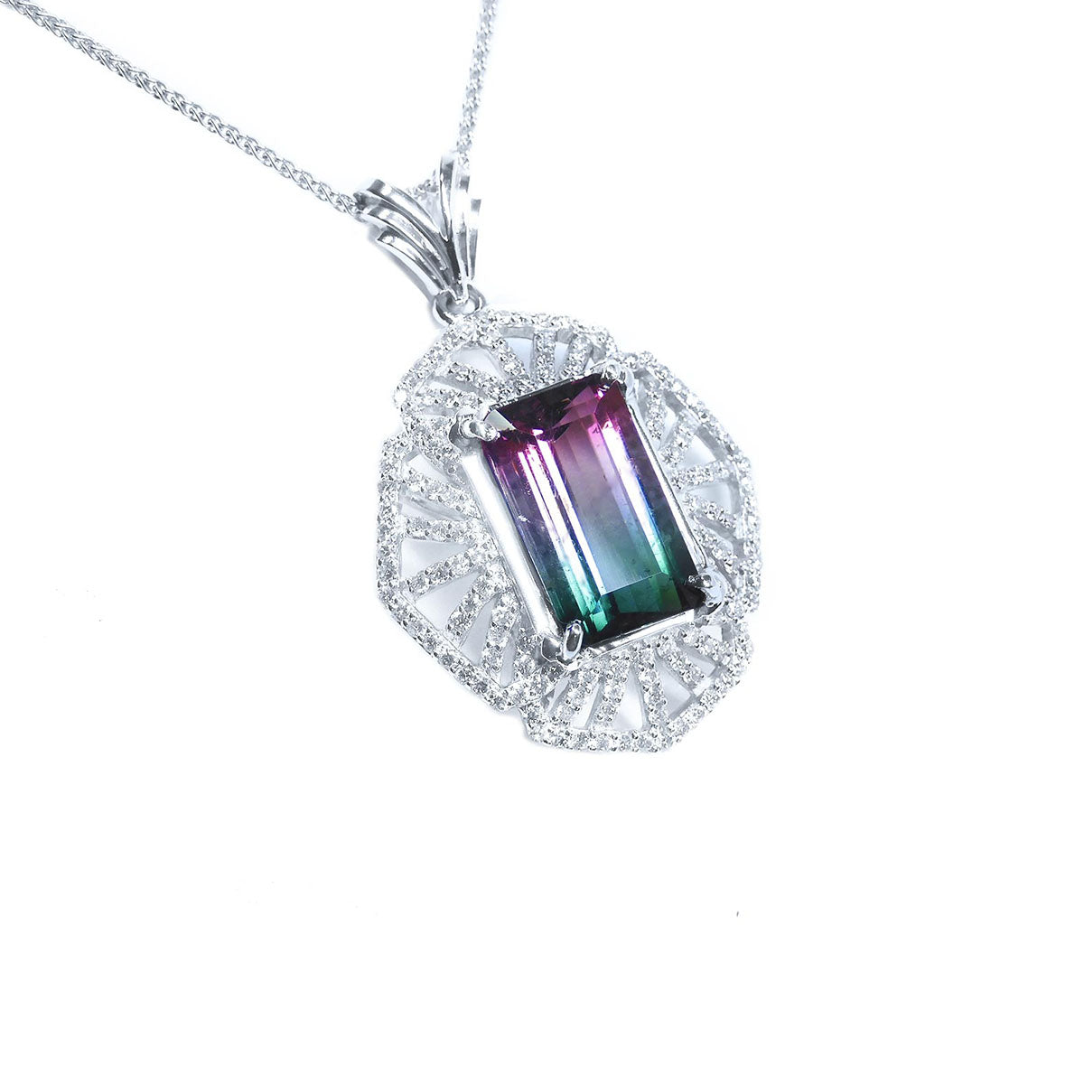 A watermelon tourmaline pendant necklace with a rectangular emerald cut and accenting natural diamonds set in 14k white gold.