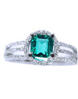 An affordable emerald engagement ring and diamond-studded band on a white background.