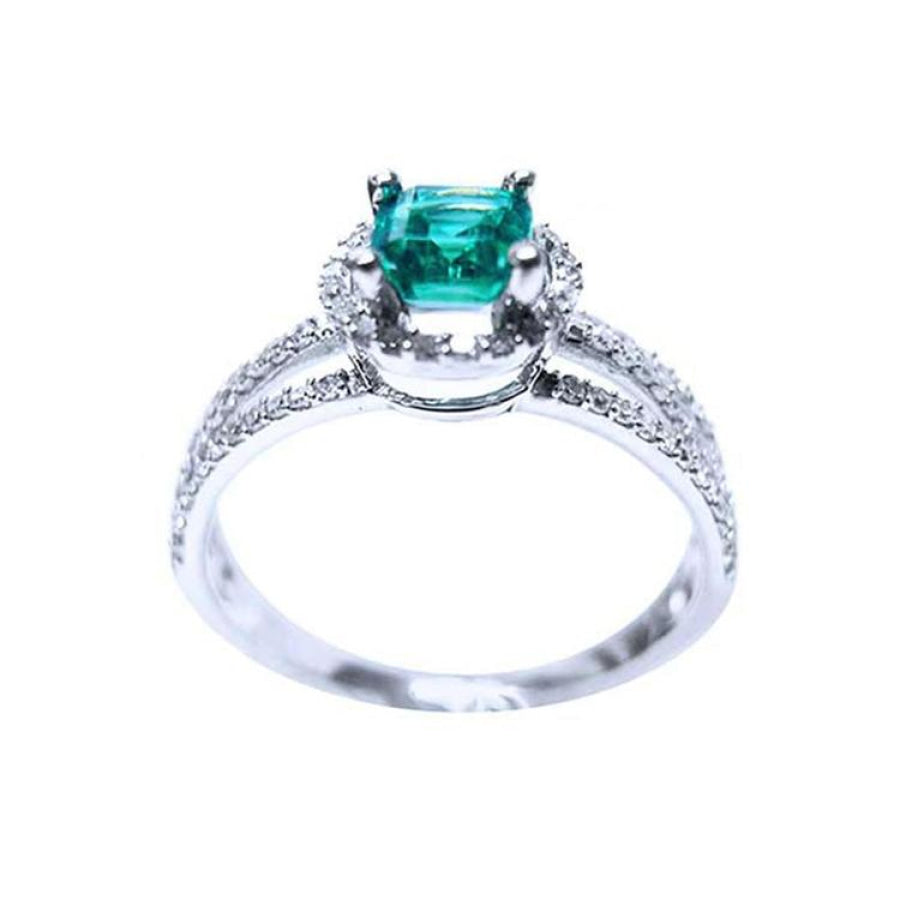 14K white gold engagement ring with a square emerald centerpiece and three rows of halo diamonds.