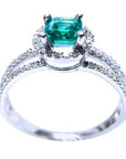 the top and partial side angle of a natural emerald engagement ring.