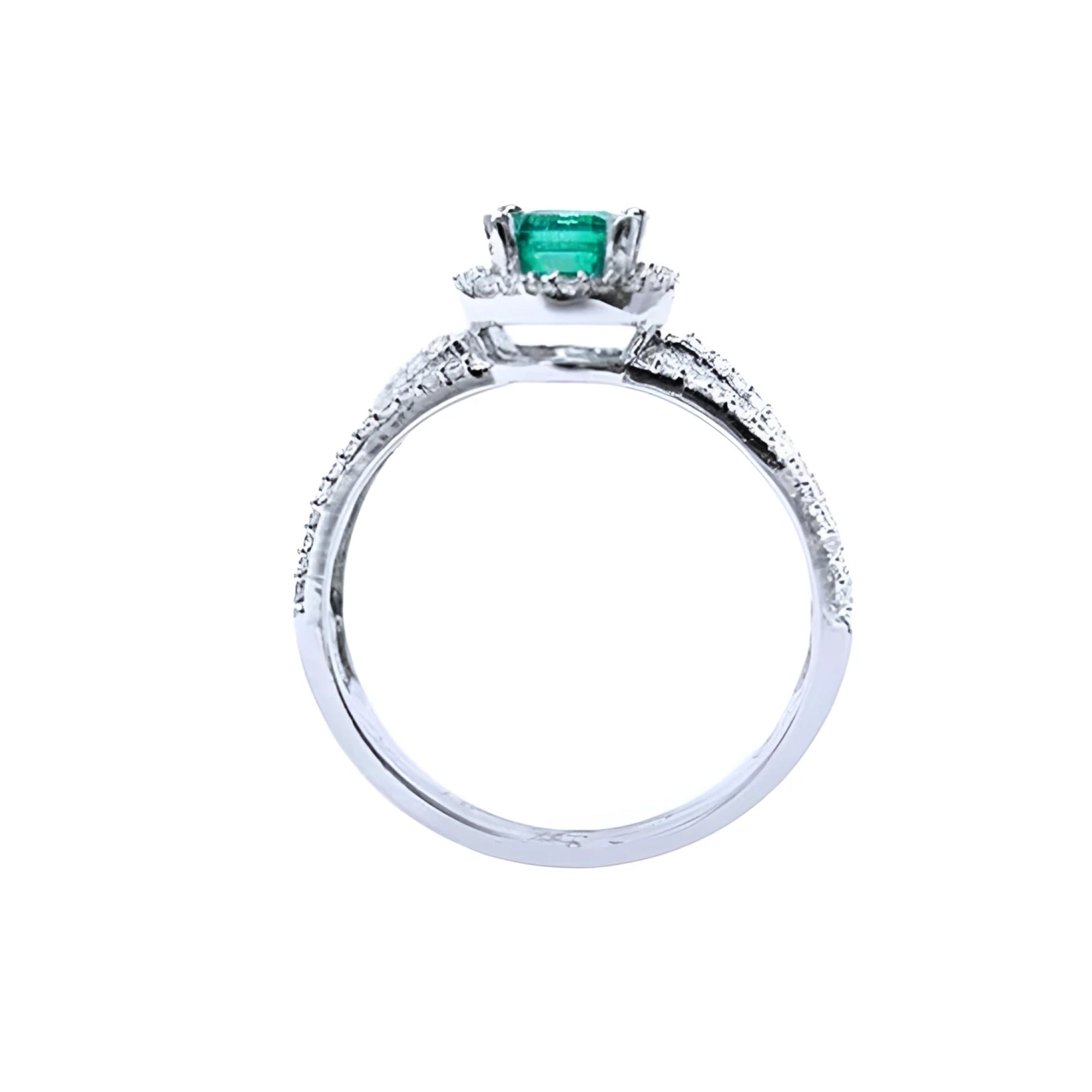 14K white gold engagement ring with a natural emerald centerpiece and three rows of halo diamonds.