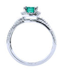 The top and lateral perspective of this natural emerald engagement ring on a white background.