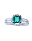 An affordable emerald engagement ring and diamond-studded band crafted in 14k white gold.