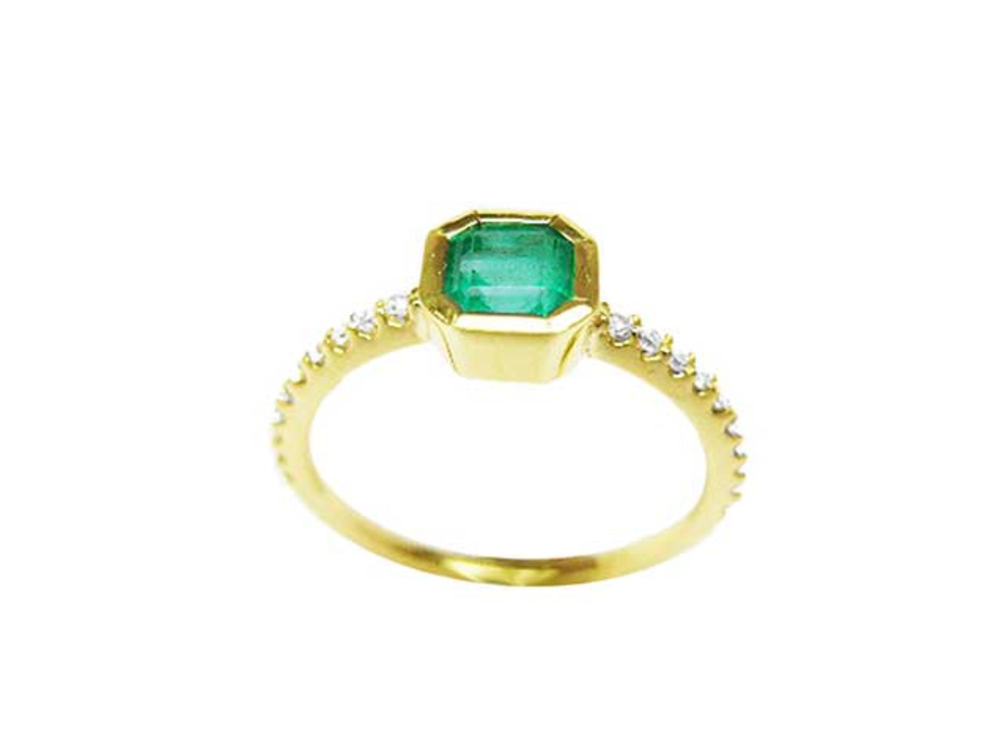 Showcasing the top emerald bezel set, gallery, and band of a Colombian emerald ring.