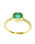 Showcasing the top emerald bezel set, gallery, and band of a Colombian emerald ring.