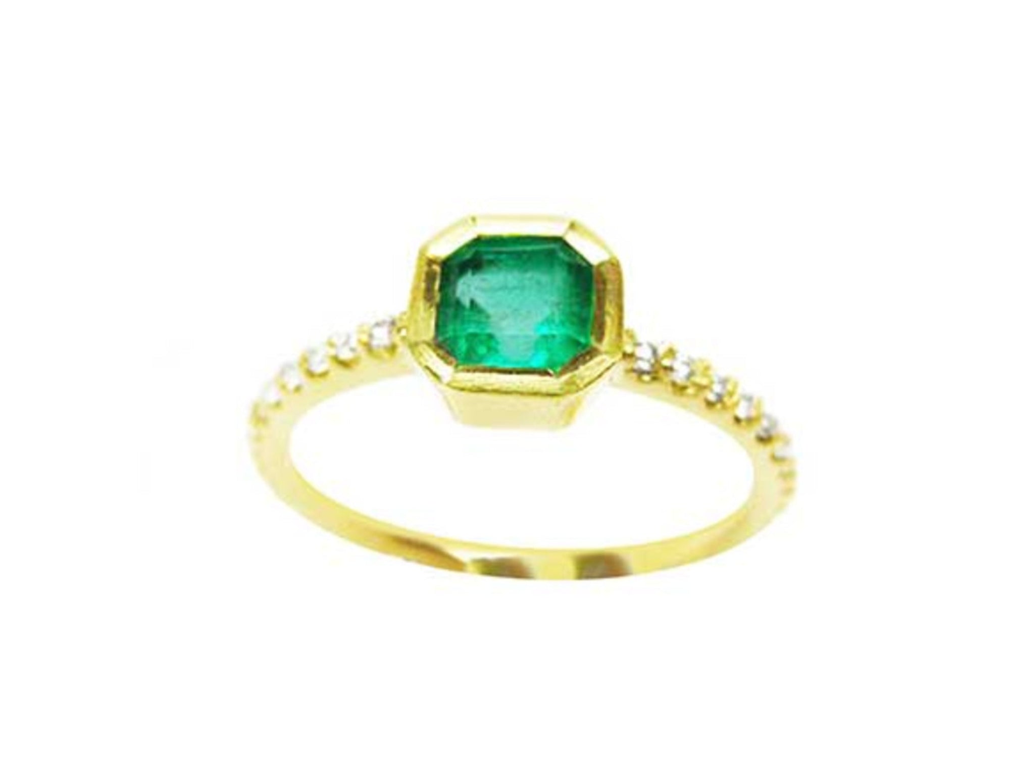 A medium green Colombian emerald ring bezel set with a tapered bezel set in a 14K gold band