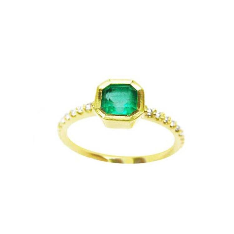 A medium green Colombian emerald ring bezel set with a tapered bezel set in a 14K gold band.