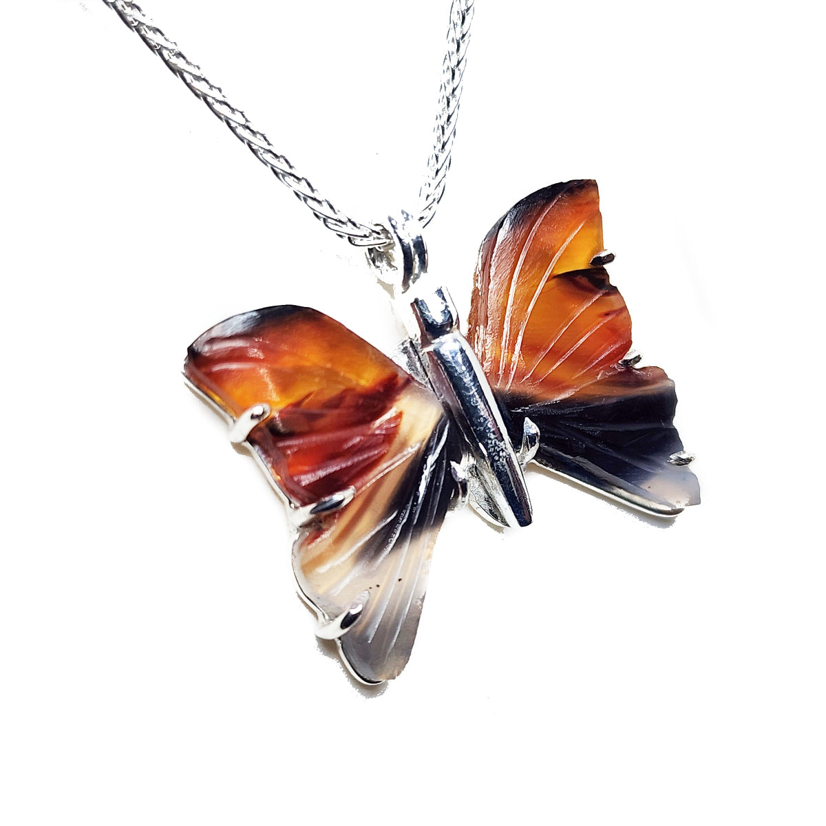 Agate butterfly-shaped pendant necklace with wings design on a silver chain against a white background.