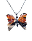 Butterfly-shaped agate pendant silver on a chain against a white background