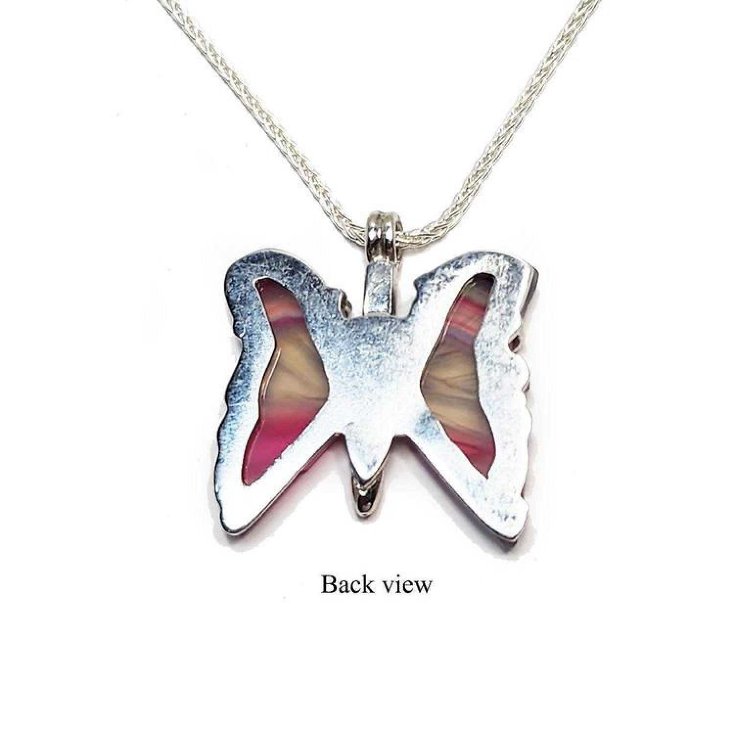 Back view of a silver butterfly agate pendant with pink wings on a silver chain.