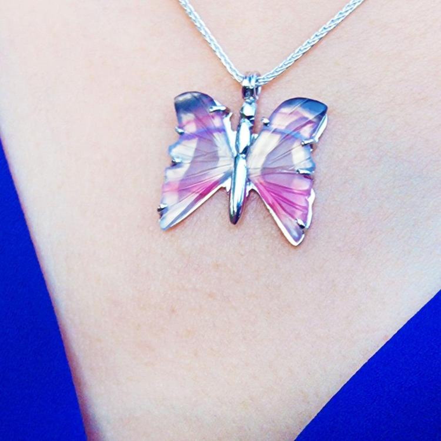 Handcrafted sterling silver butterfly agate pendant necklace with pink and colorful wings.