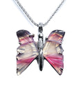 Butterfly-shaped agate sterling silver pendant with pink and purple wings on a white background