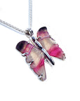 Agate butterfly-shaped sterling silver pendant with pink and purple wings on a white background