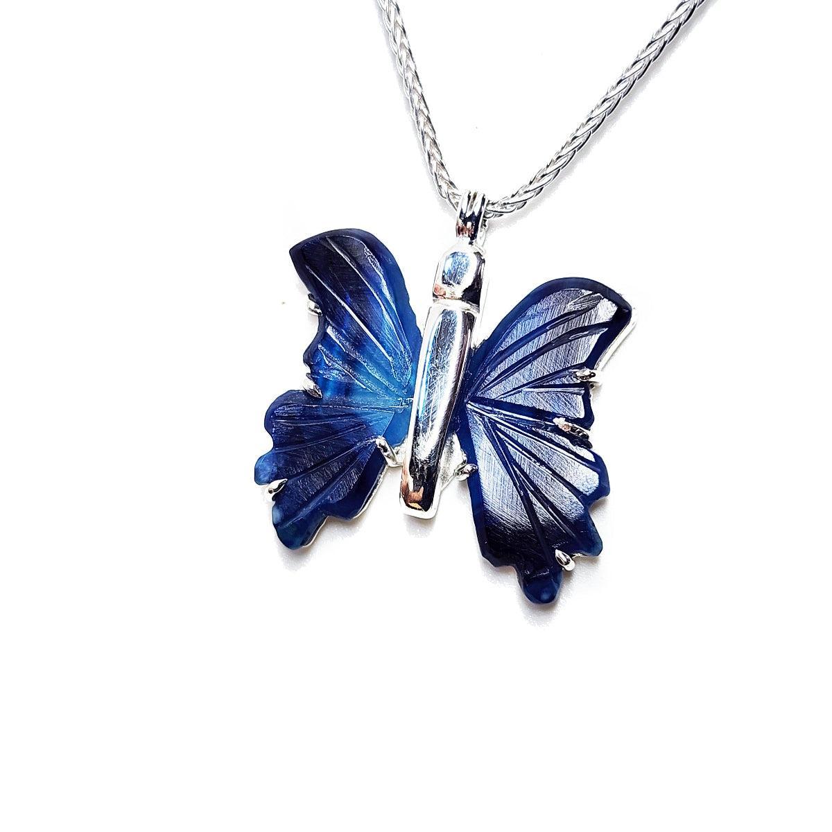 Blue agate butterfly sterling silver pendant on a white background