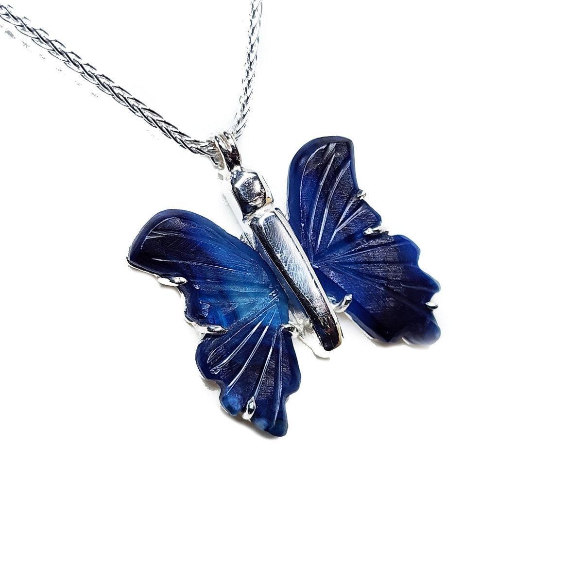 Blue agate butterfly pendant on a silver chain against a white background
