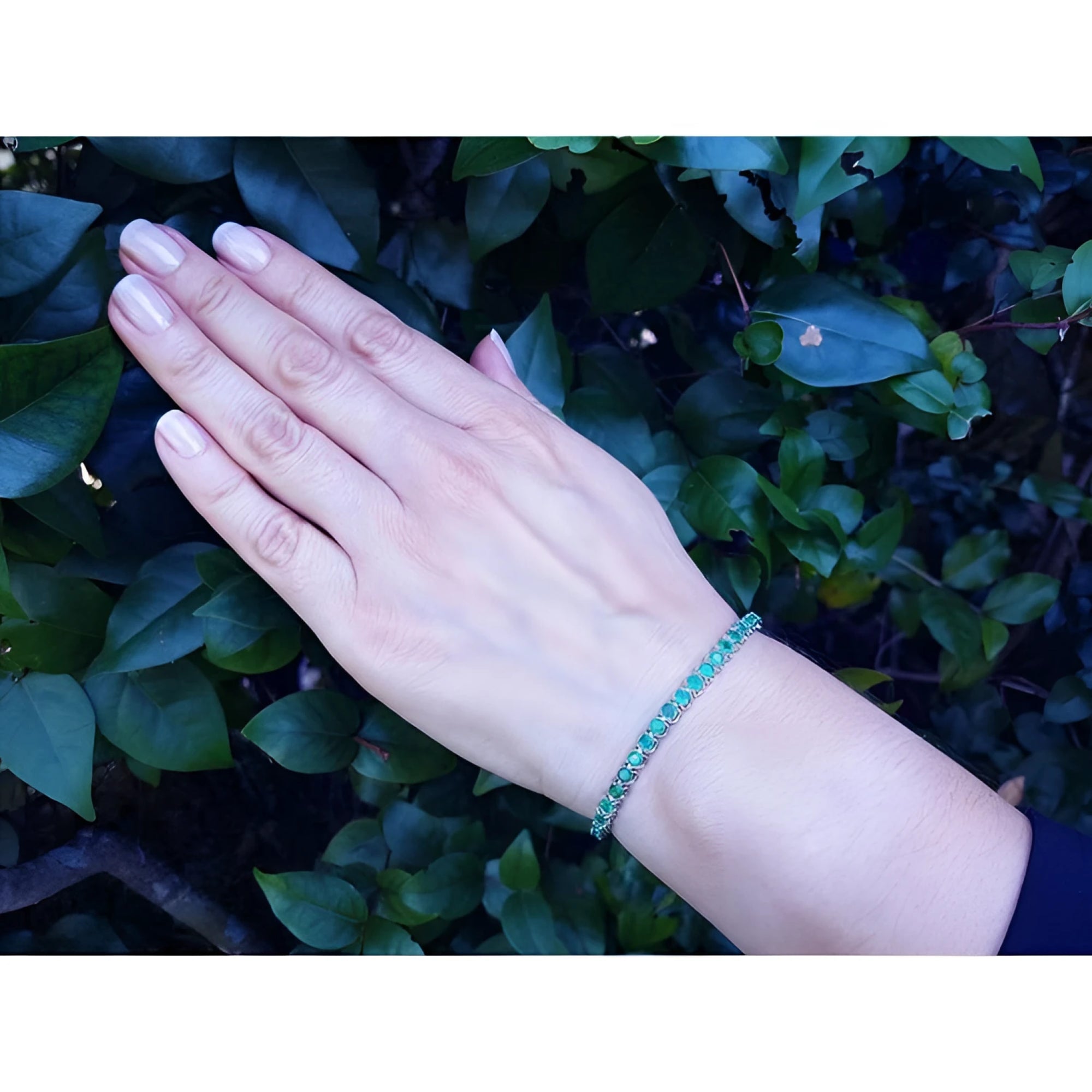 Hand modeling a 14K white gold tennis bracelet with sparkling round Colombian emeralds.