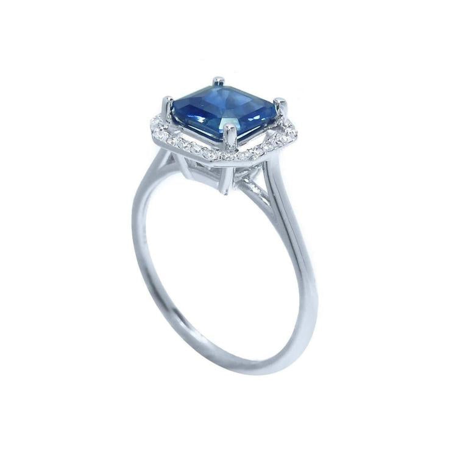 Asscher cut blue sapphire ring with halo diamonds in 18k white gold.