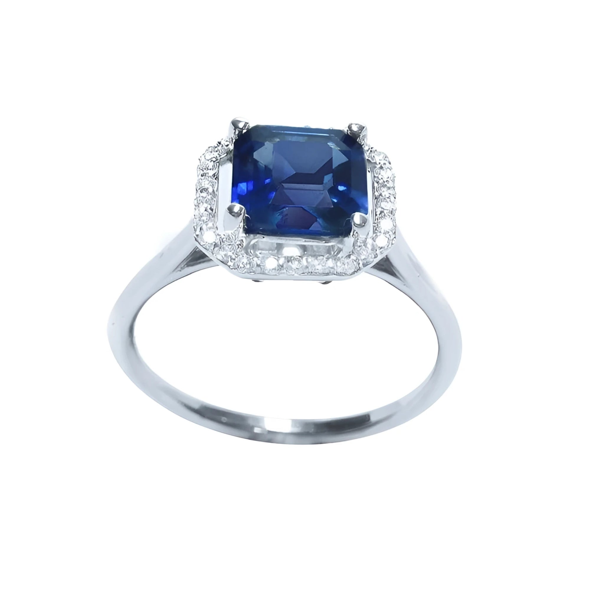 Asscher cut medium dark blue sapphire ring with halo diamonds in 18k white gold.