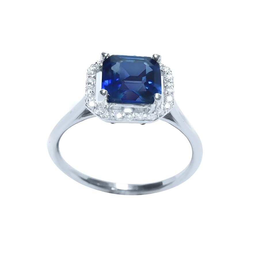Asscher cut medium dark blue sapphire ring with halo diamonds in 18k white gold.