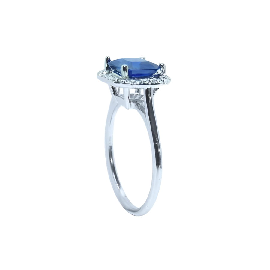 Asscher cut blue sapphire ring with halo diamonds in 18k white gold.