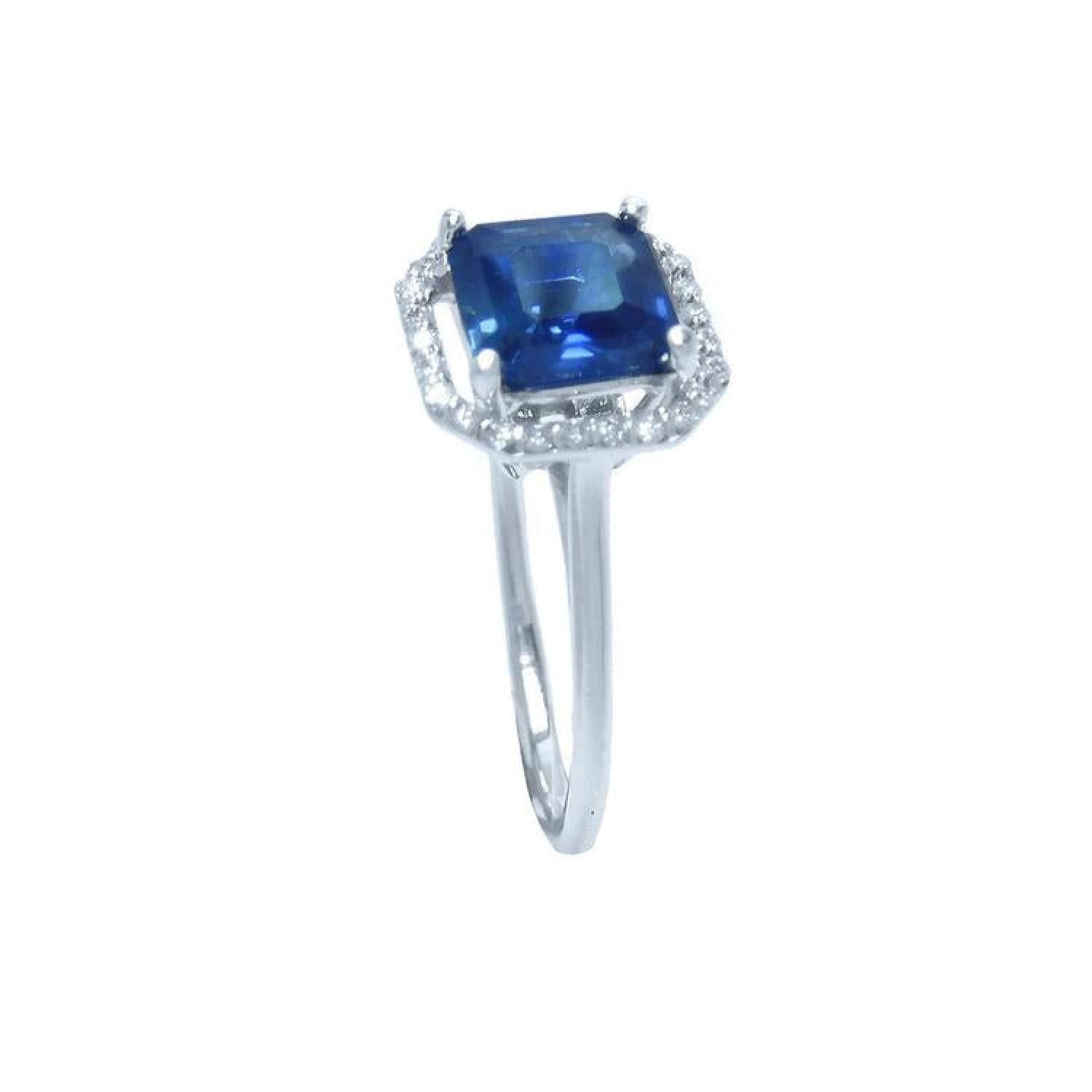 Asscher cut blue sapphire ring with halo diamonds in 18k white gold.