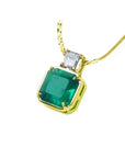 18K yellow gold necklace with a large asscher cut Colombian emerald and a princess cut diamond.