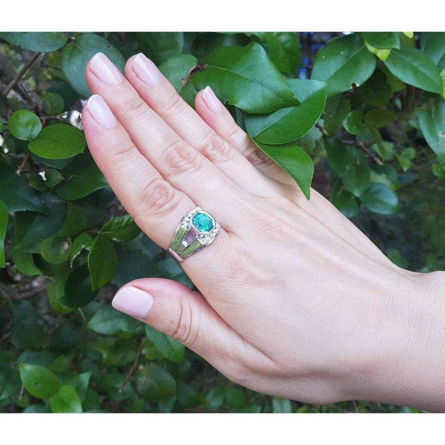 Asscher cut 1.94 ct. bluish-green emerald ring in 18K white gold, worn on a hand.