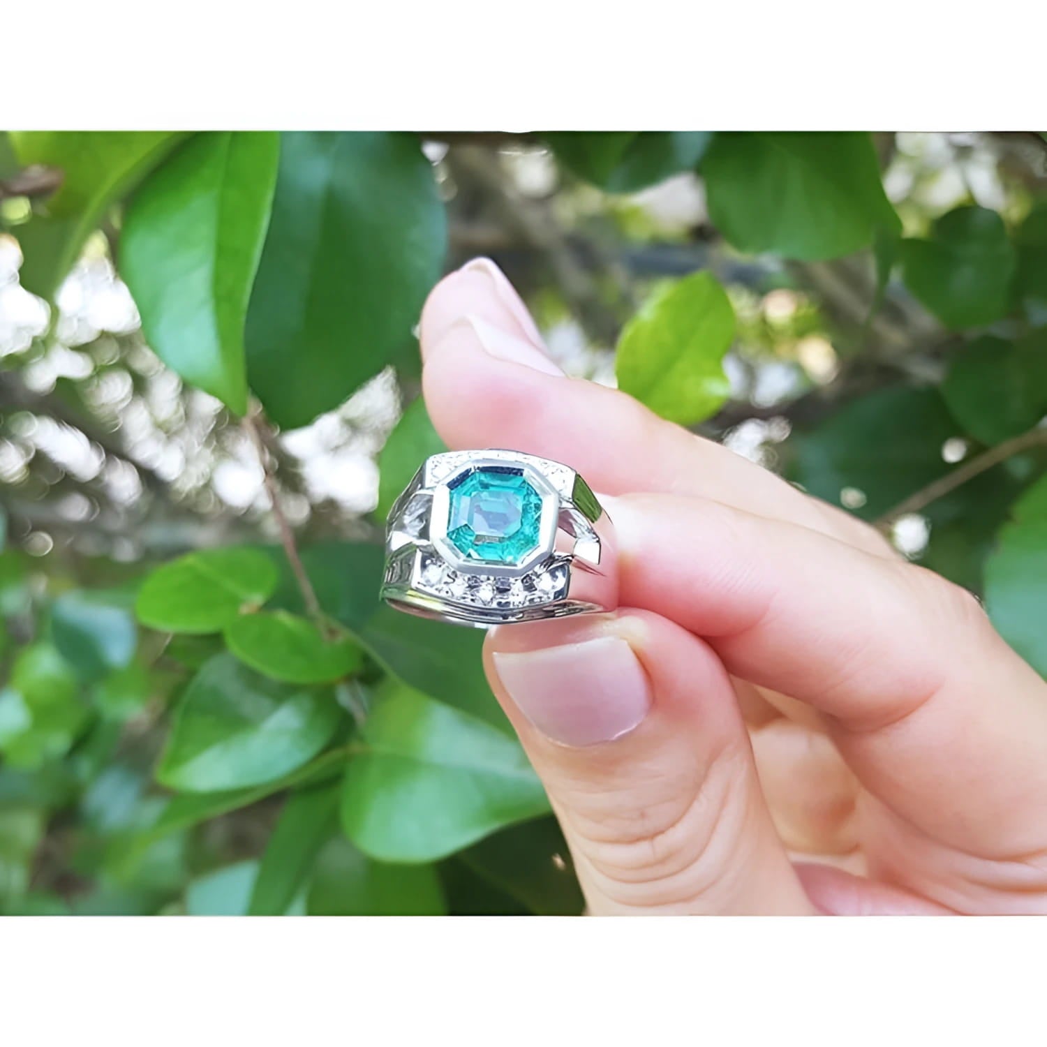 1.94 ct. Asscher cut men's emerald ring in 18K white gold, bezel set, vibrant bluish-green.