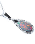 An 18k white gold pendant necklace featuring a pear-shaped Australian opal with a multicolored play of colors.