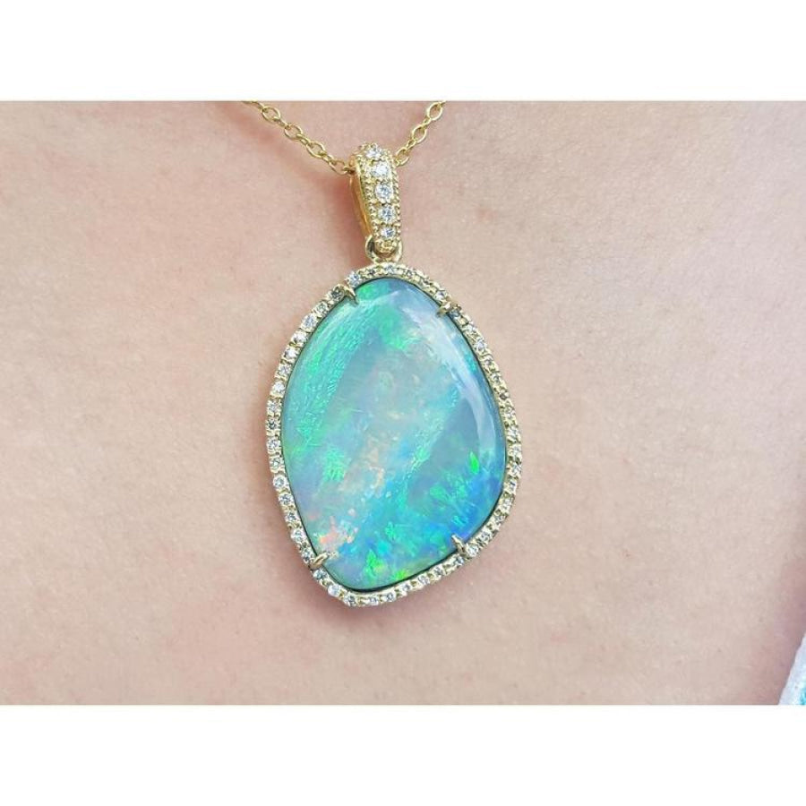 12.16 ct. Australian opal pendant with bluish-green play-of-color, set in 18K yellow gold.
