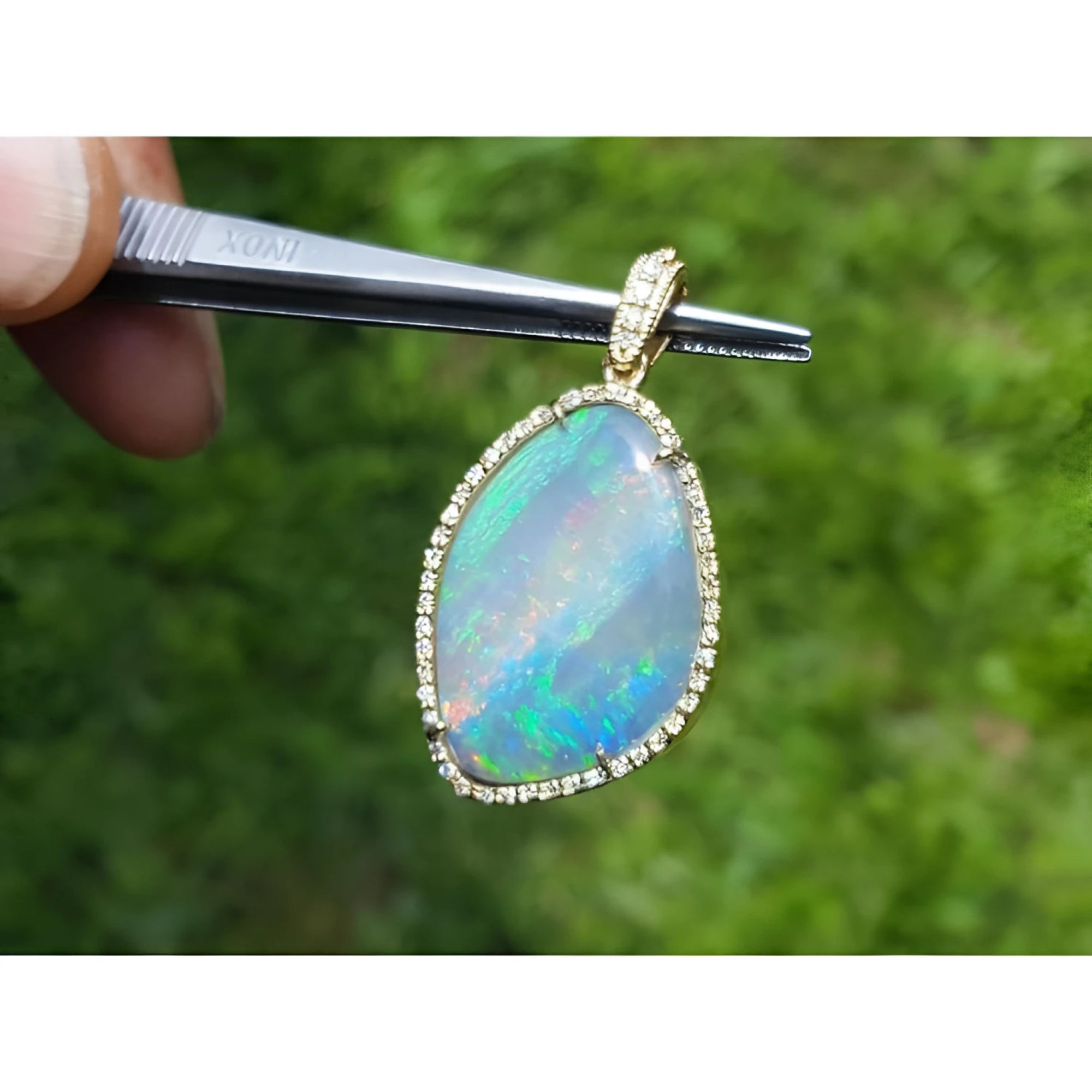12.16 ct. Australian opal pendant with bluish-green play-of-color, handcrafted in 18K yellow gold.
