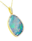 Opal pendant with gold and diamonds frame and chain on right side with top view profile.
