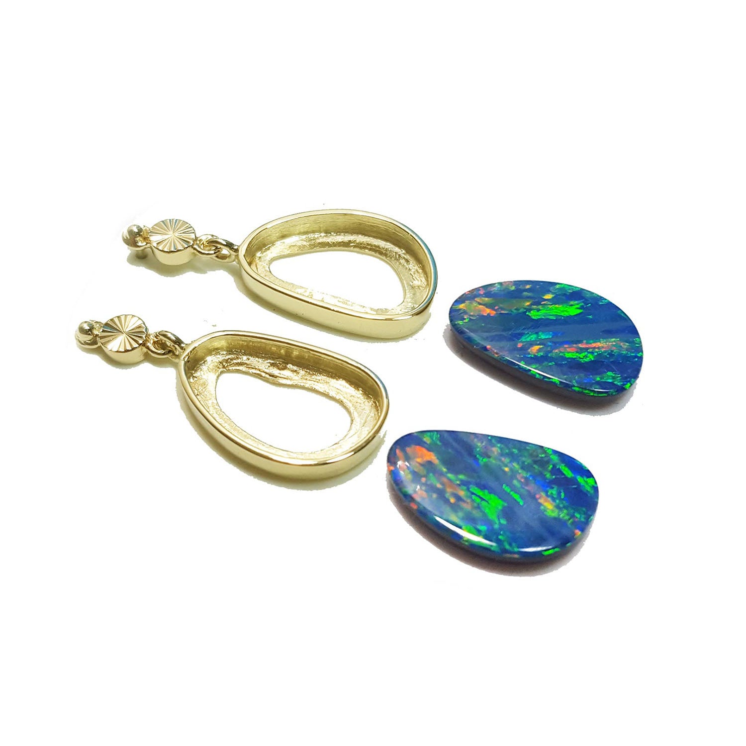 Gold earrings mountings with colorful opal stones aside on a white background.