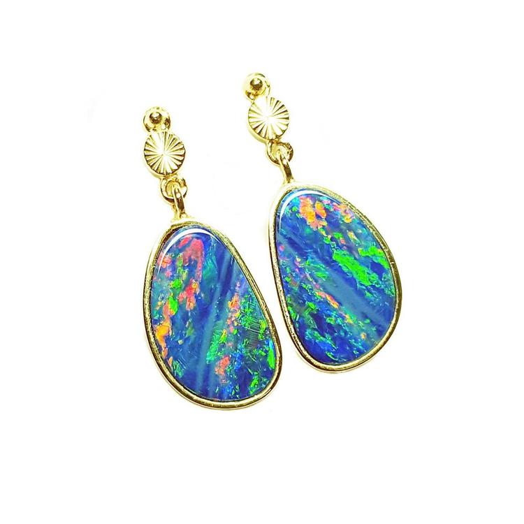 Opal earrings with gold setting on a topside view position.
