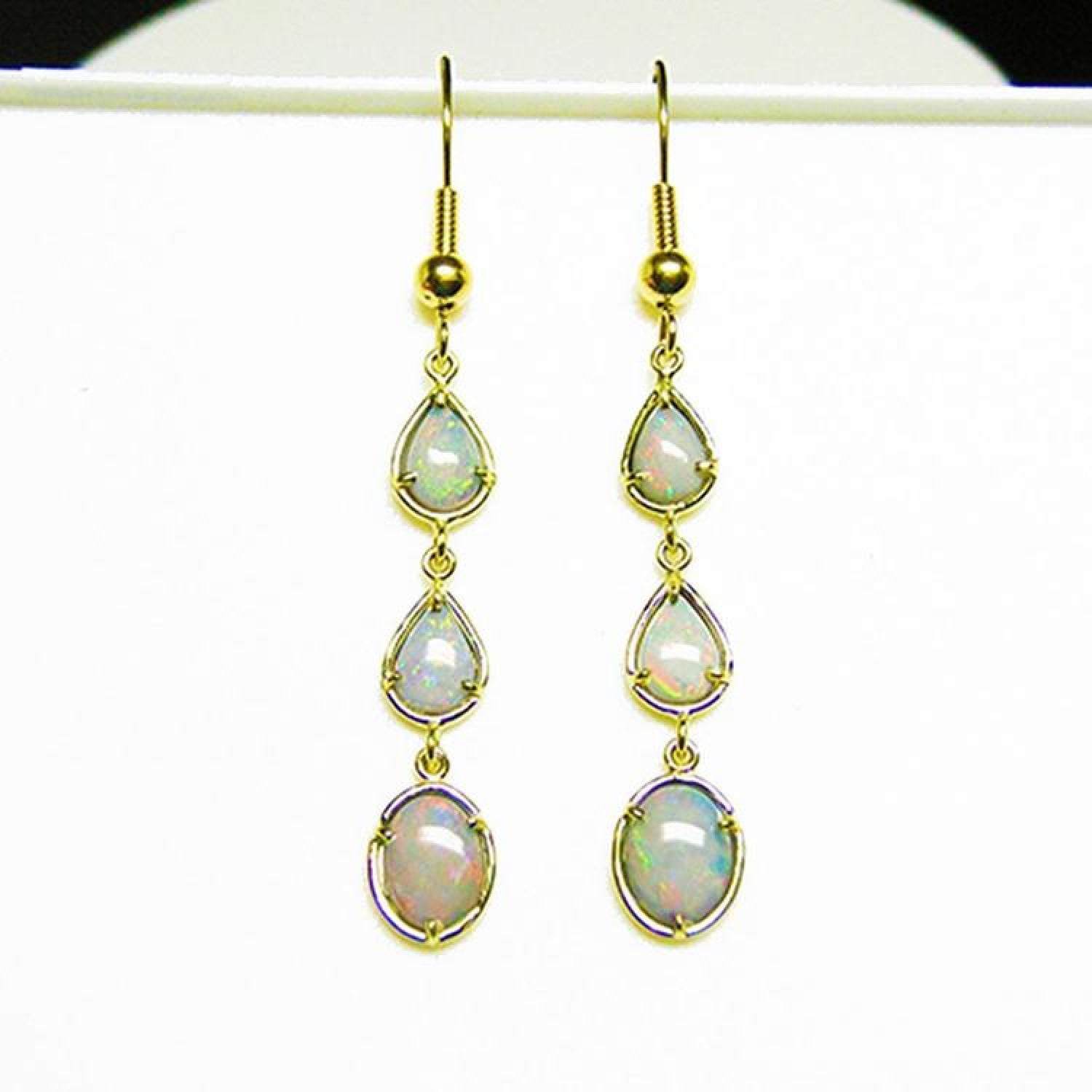 Pear and oval Australian opal dangle earrings in 14k yellow gold.