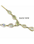 Gold necklace with opal stones on a upside down position to display its back side view.