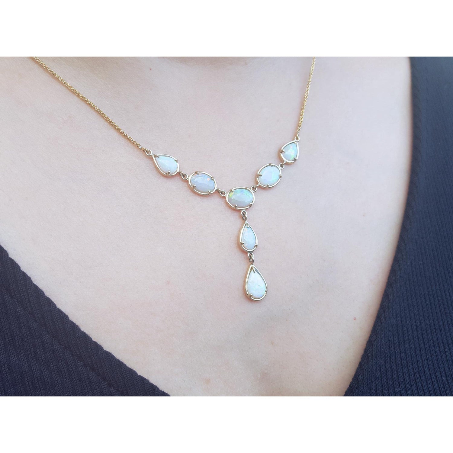 Necklace with natural opal stones worn by a person.