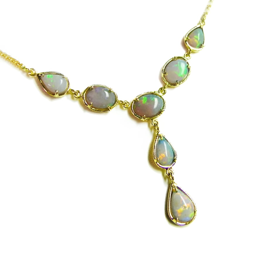 Handcrafted 14K yellow gold necklace with multiple iridescent Australian opal gemstones in oval and teardrop shapes.