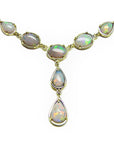 Australian opal necklace with gold setting, topside view position on a white background.