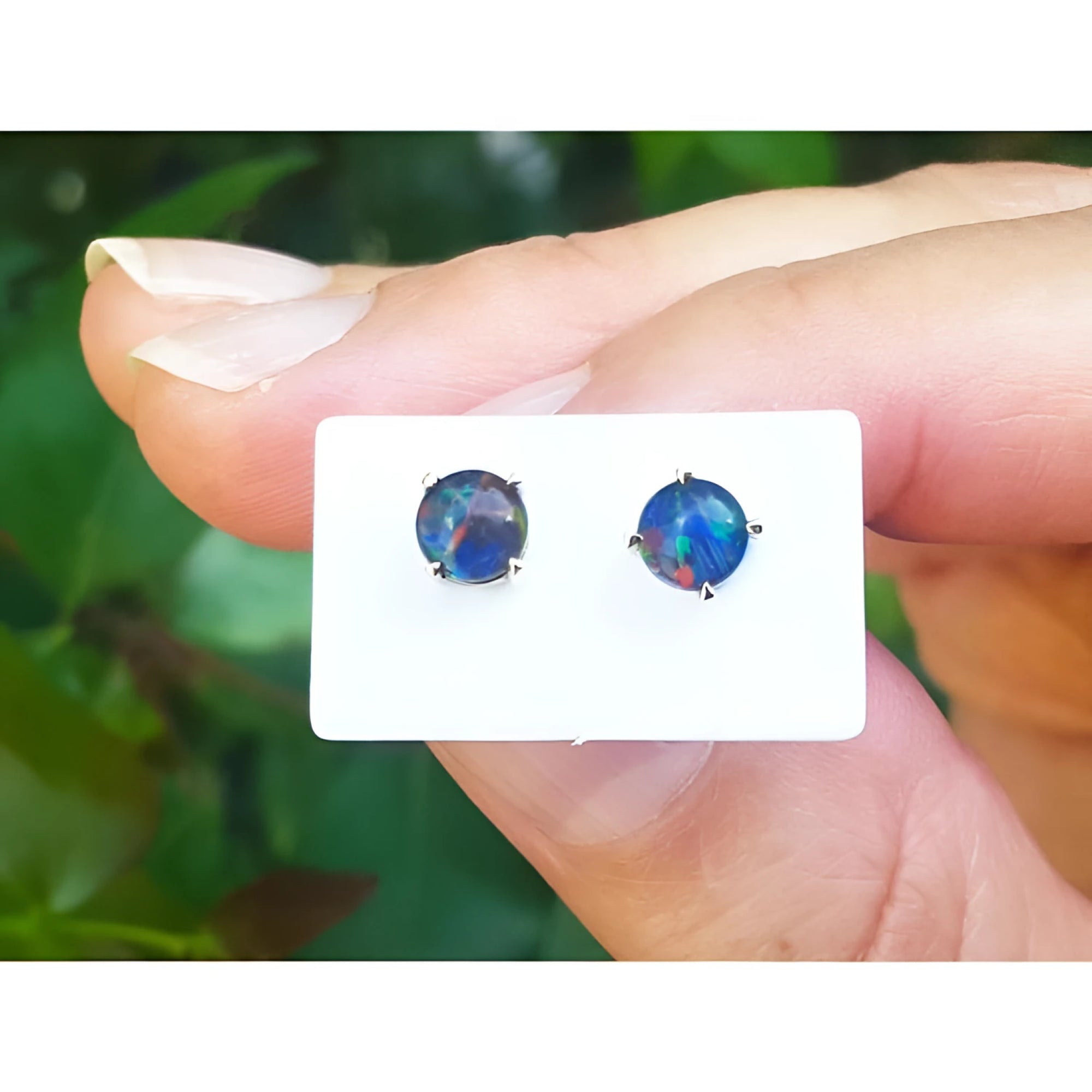 Round Australian opal doublet stud earrings with vibrant play of color, prong-set in 14K yellow gold.