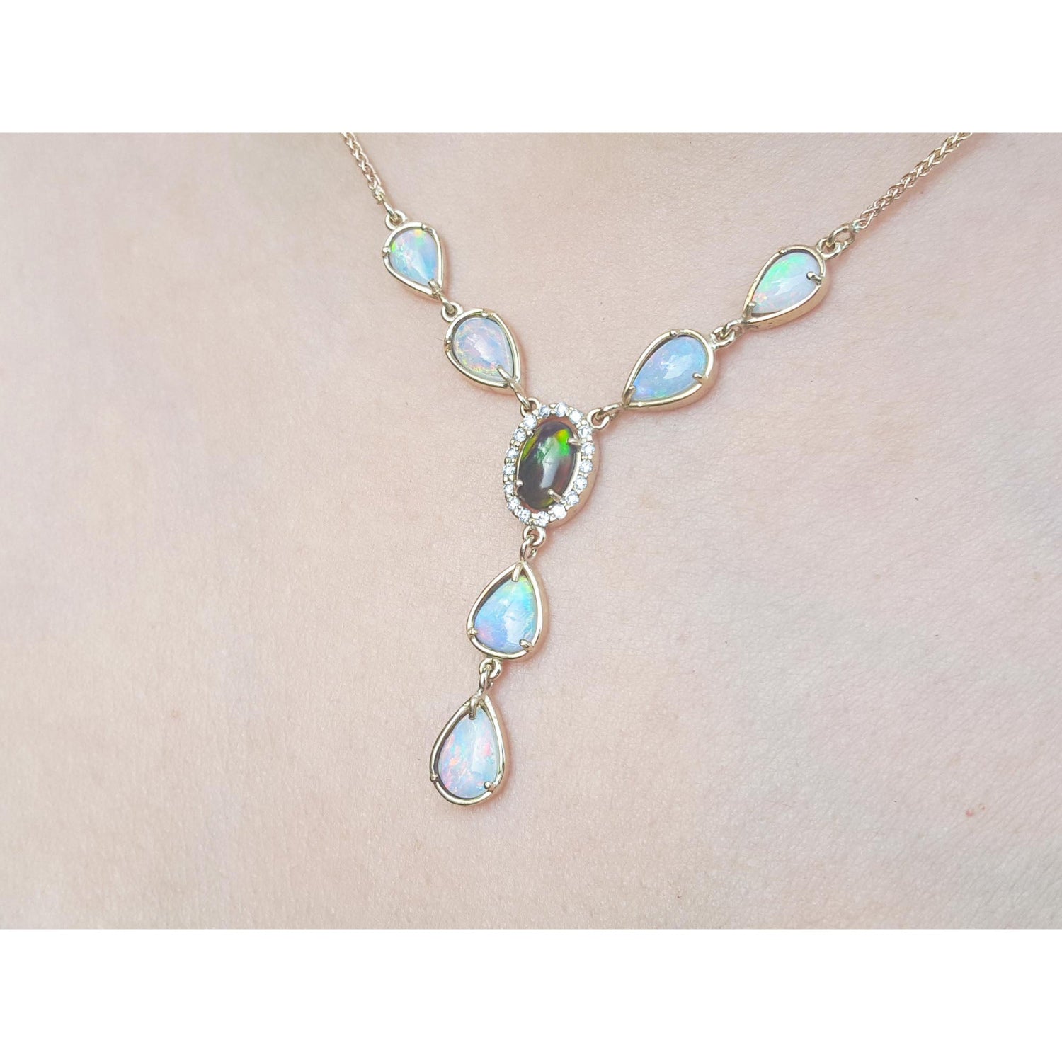 Necklace with opal stones on a light pink background