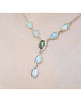 Necklace with opal stones on a light pink background