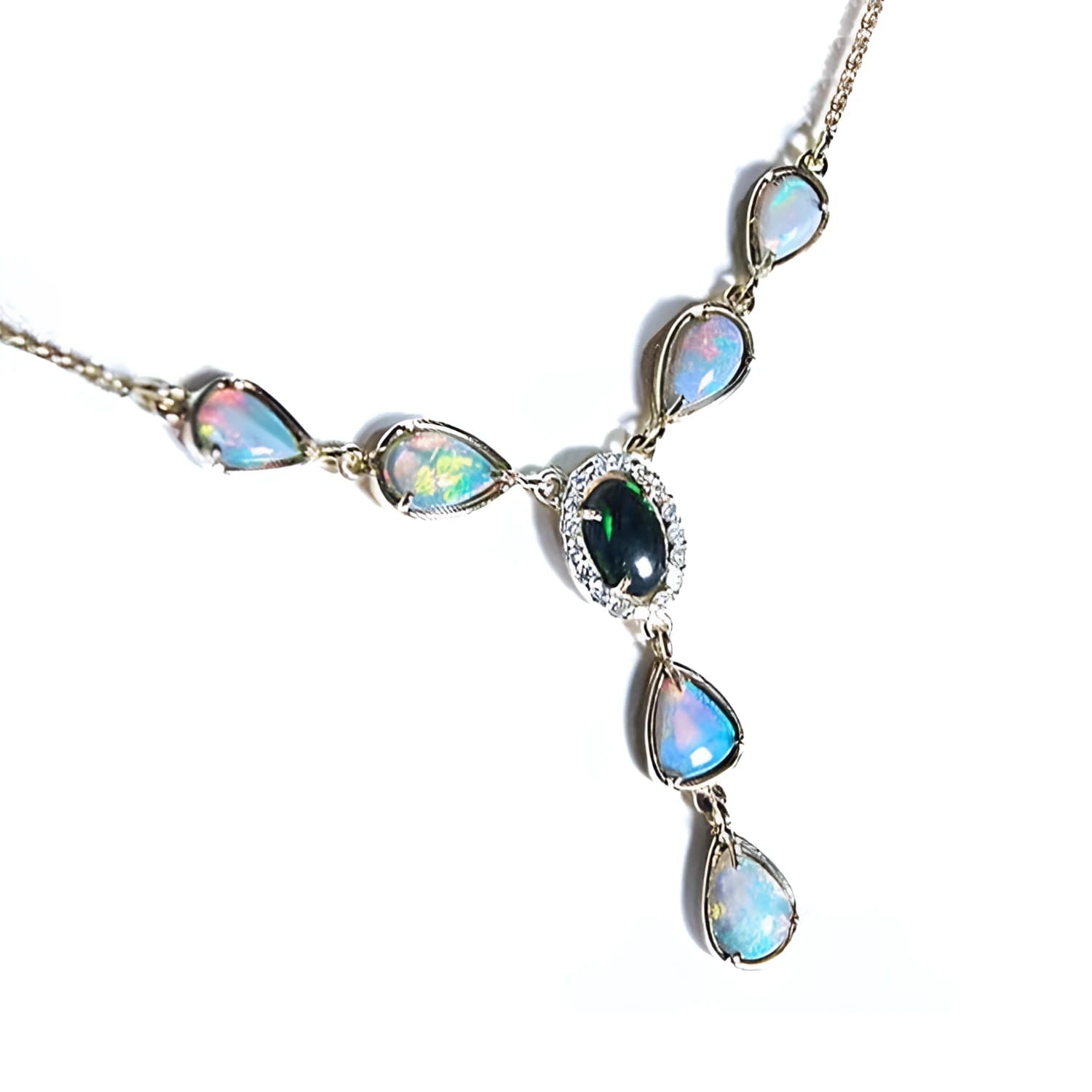 14k yellow gold necklace with a black Australian opal center, diamond halo, and pear-shaped opals.