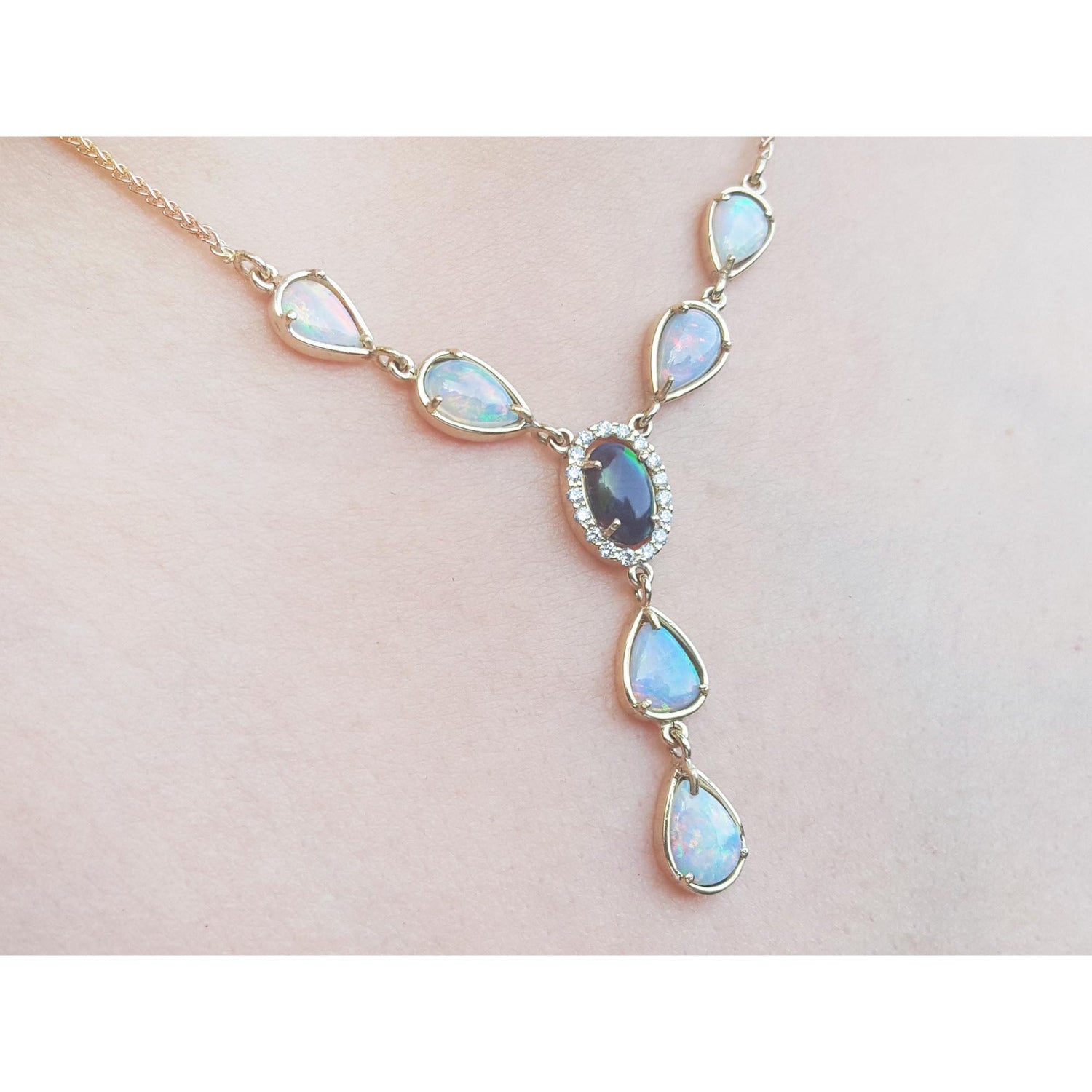 Necklace with opal stones on a light pink background