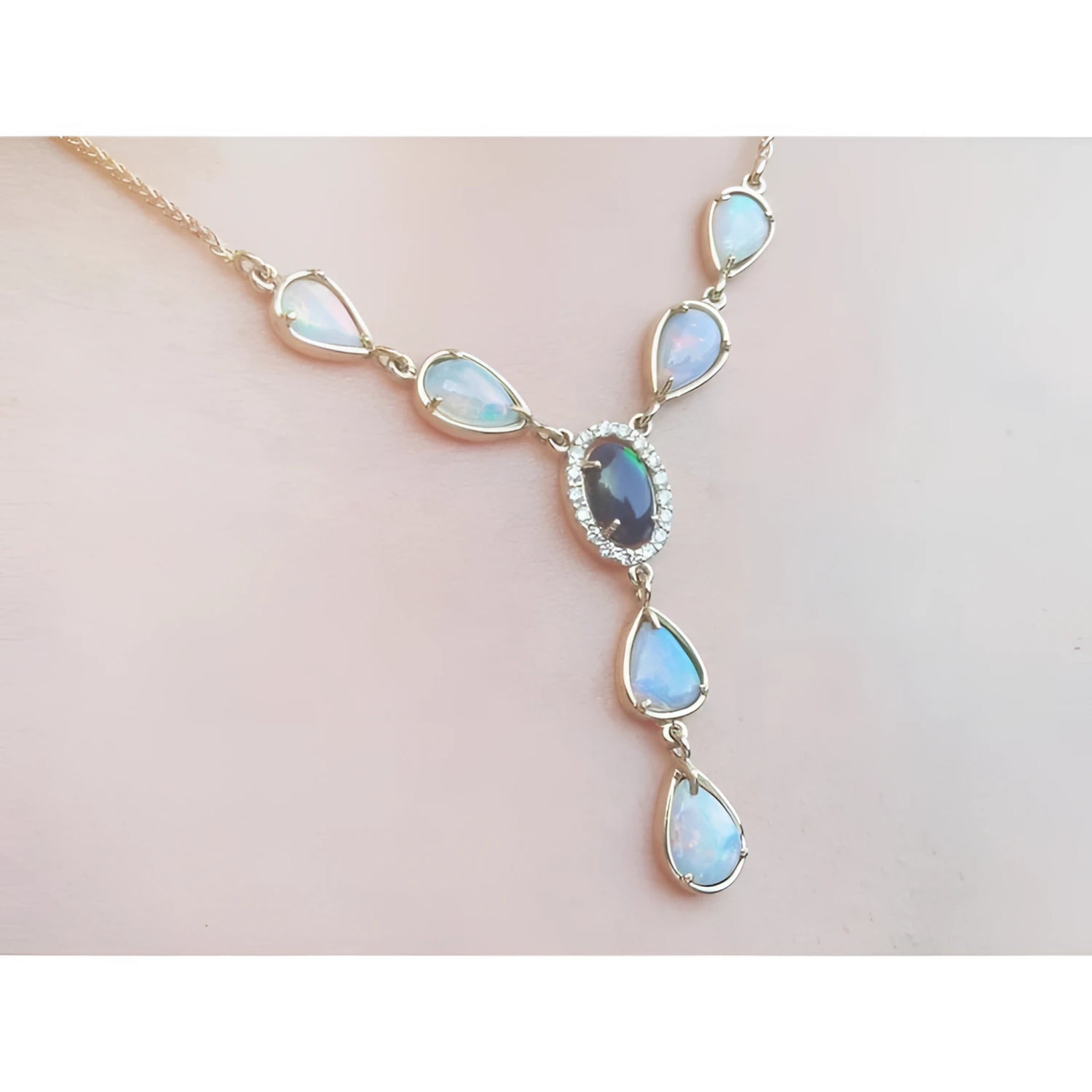 14k yellow gold Australian black opal and diamond halo necklace with teardrop opals.